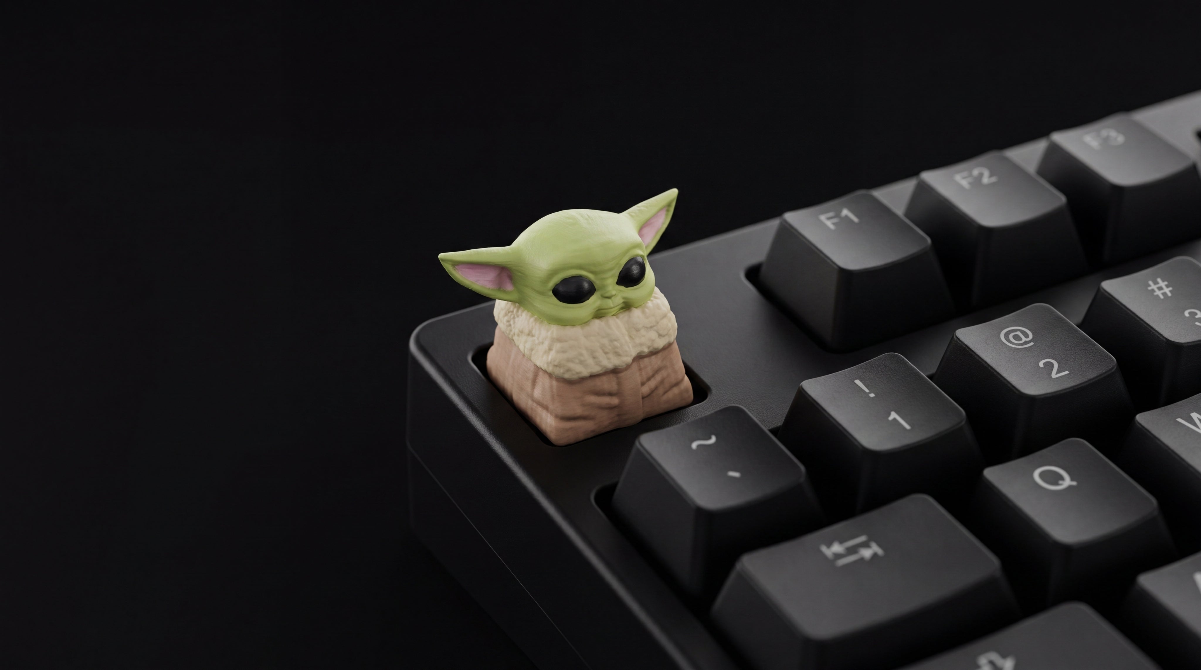 Baby Yoda on black keyboard