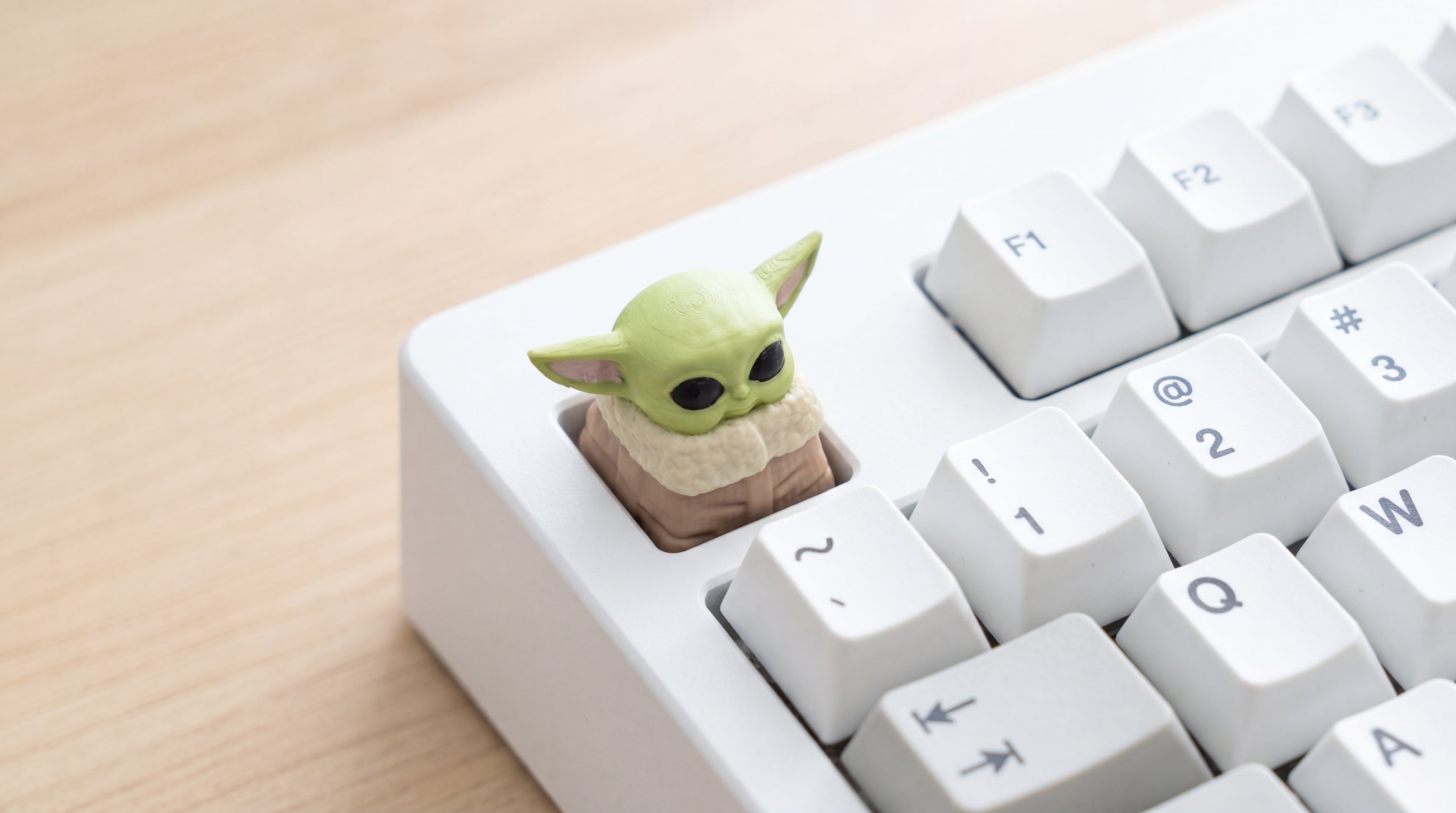 Baby Yoda on white keyboard